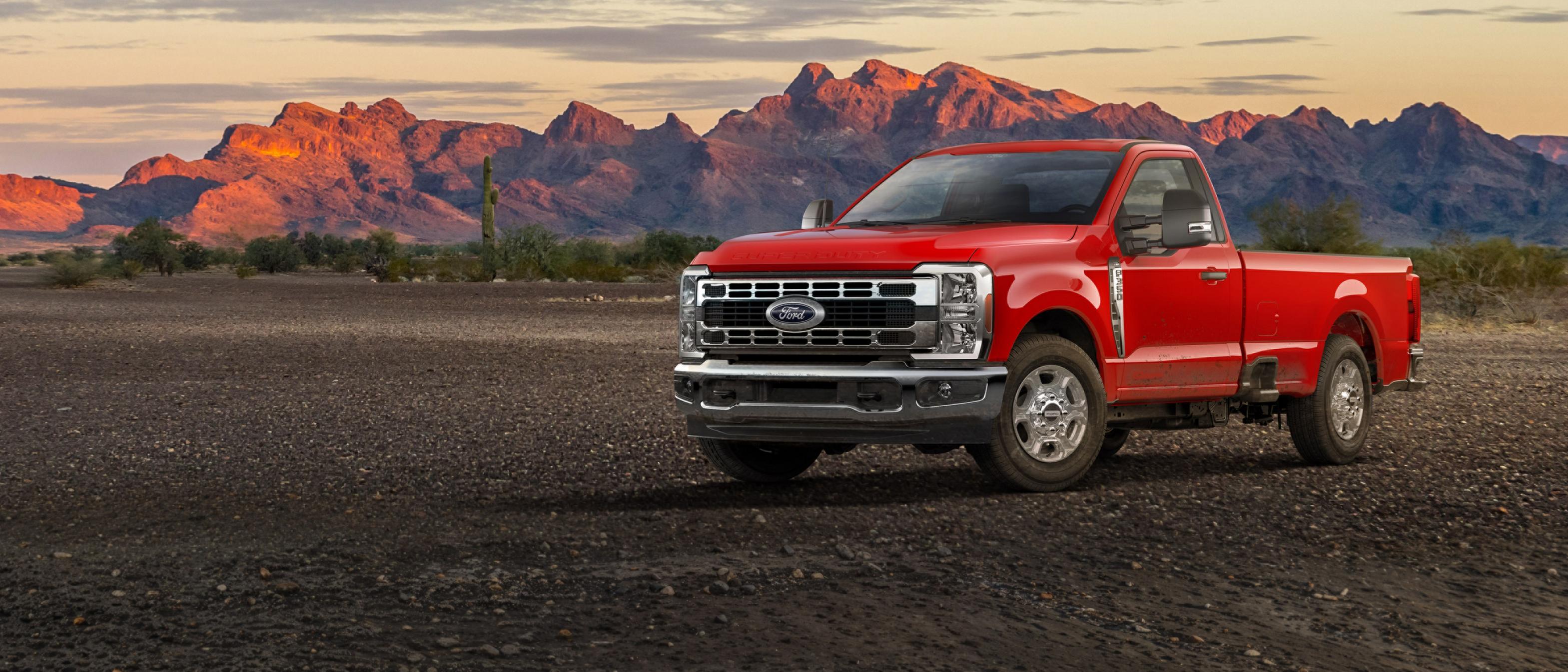 Modèle Ford Super Duty® F-350® XLT 2026 stationné sur du gravier avec des montagnes en arrière-plan