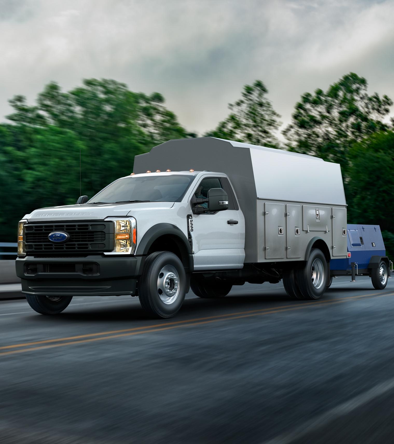 Un Ford Super Duty® à châssis-cabine 2026 avec un caisson utilitaire remorquant une génératrice