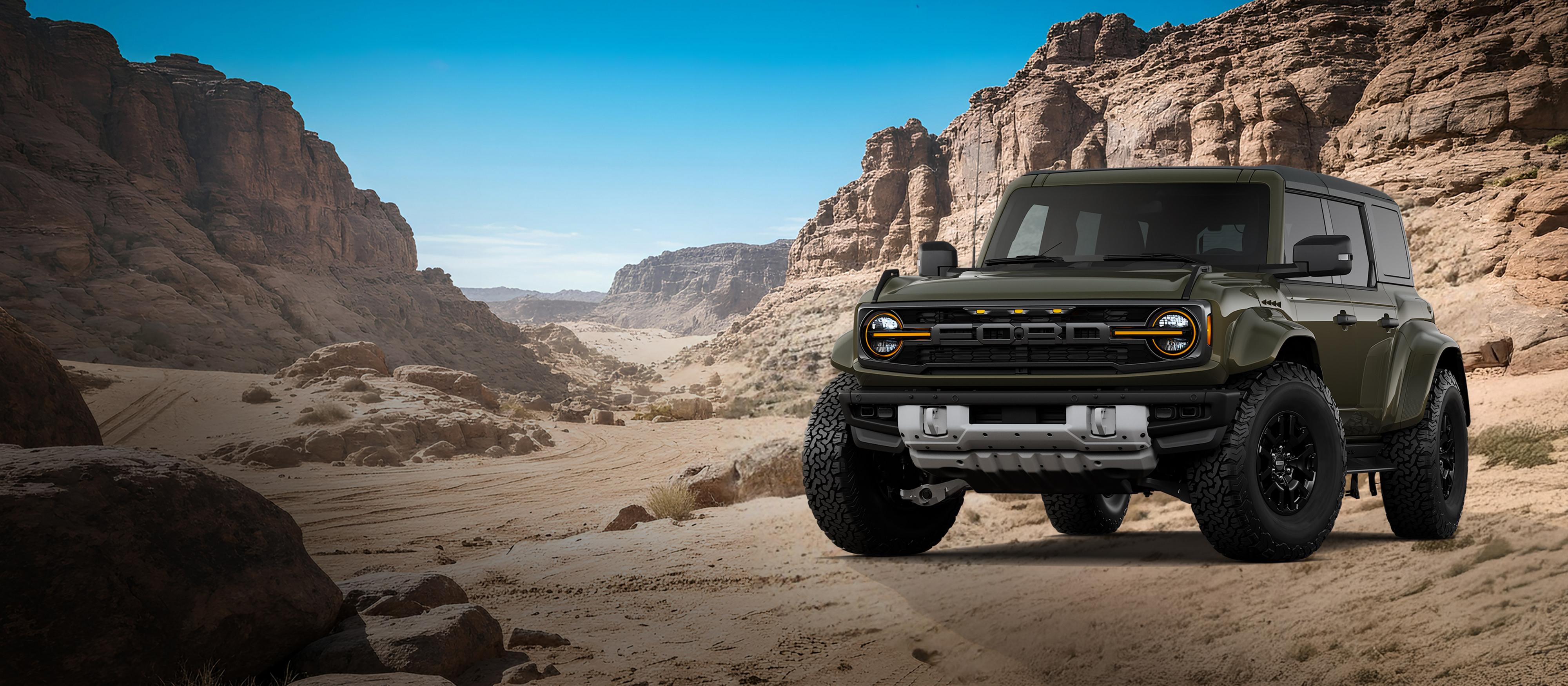 Un modèle Ford Bronco® Raptor 2026 montré en vert abri stationné sur une étendue rocheuse