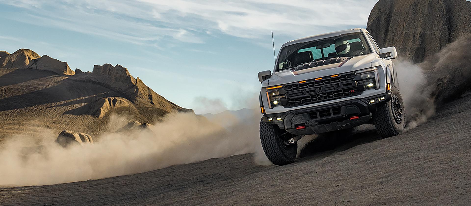 Le Ford F-150® Raptor® R® 2025 traverse le désert en laissant un sillage de poussière derrière