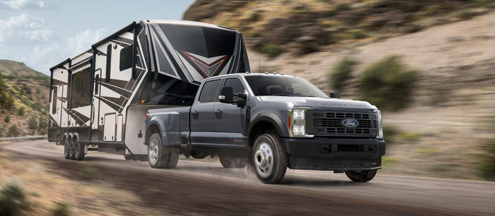 2027 Ford Super Duty® truck pulling a large trailer on a mountain road