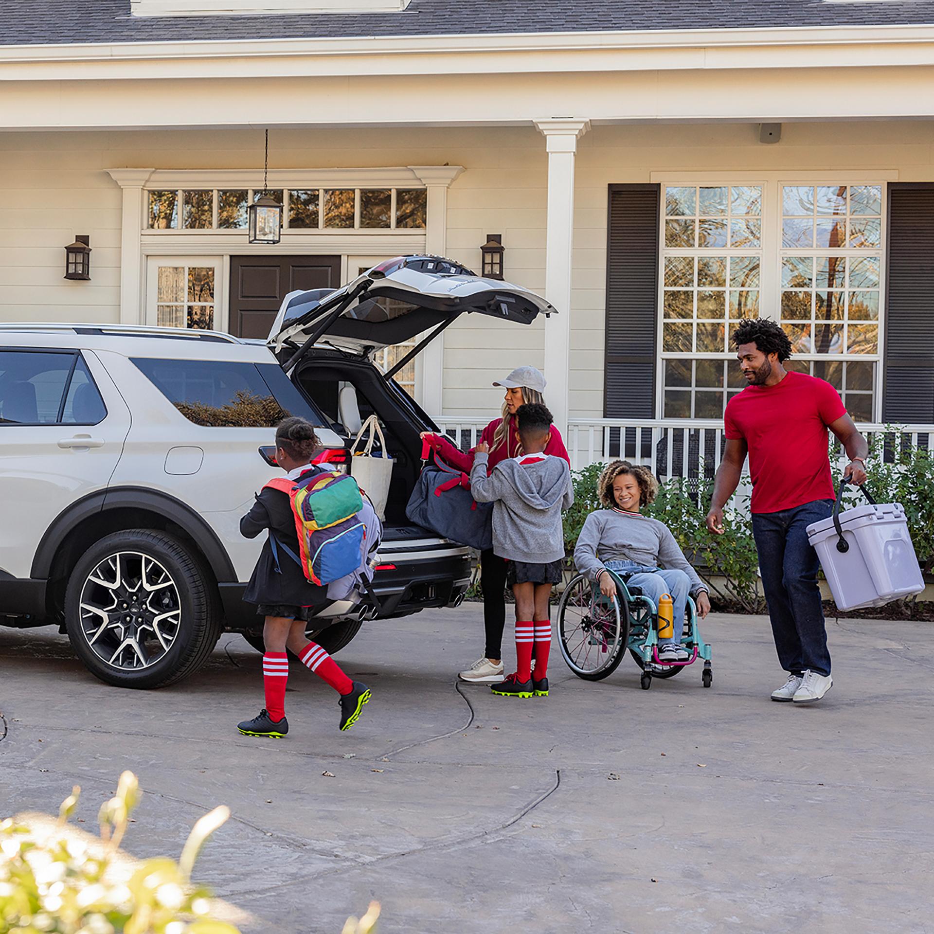 Une famille chargeant la zone de chargement arrière d’un VUS Ford Explorer® 2027