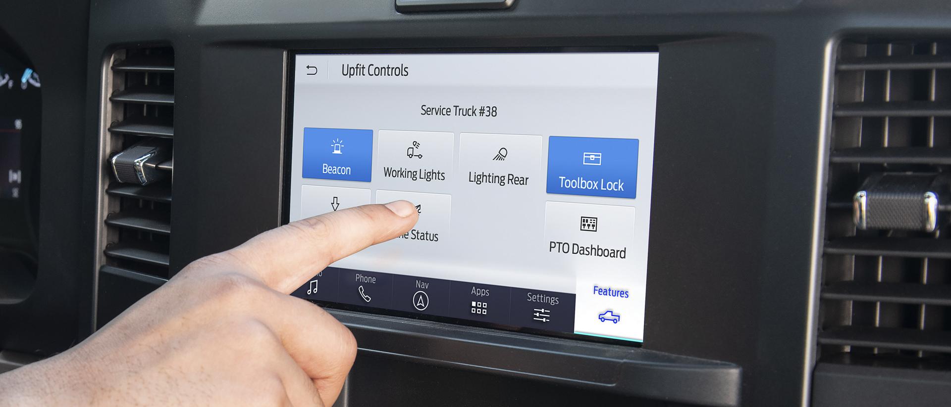 Une personne utilisant les commandes du bloc de commande sur l’écran central de huit pouces.