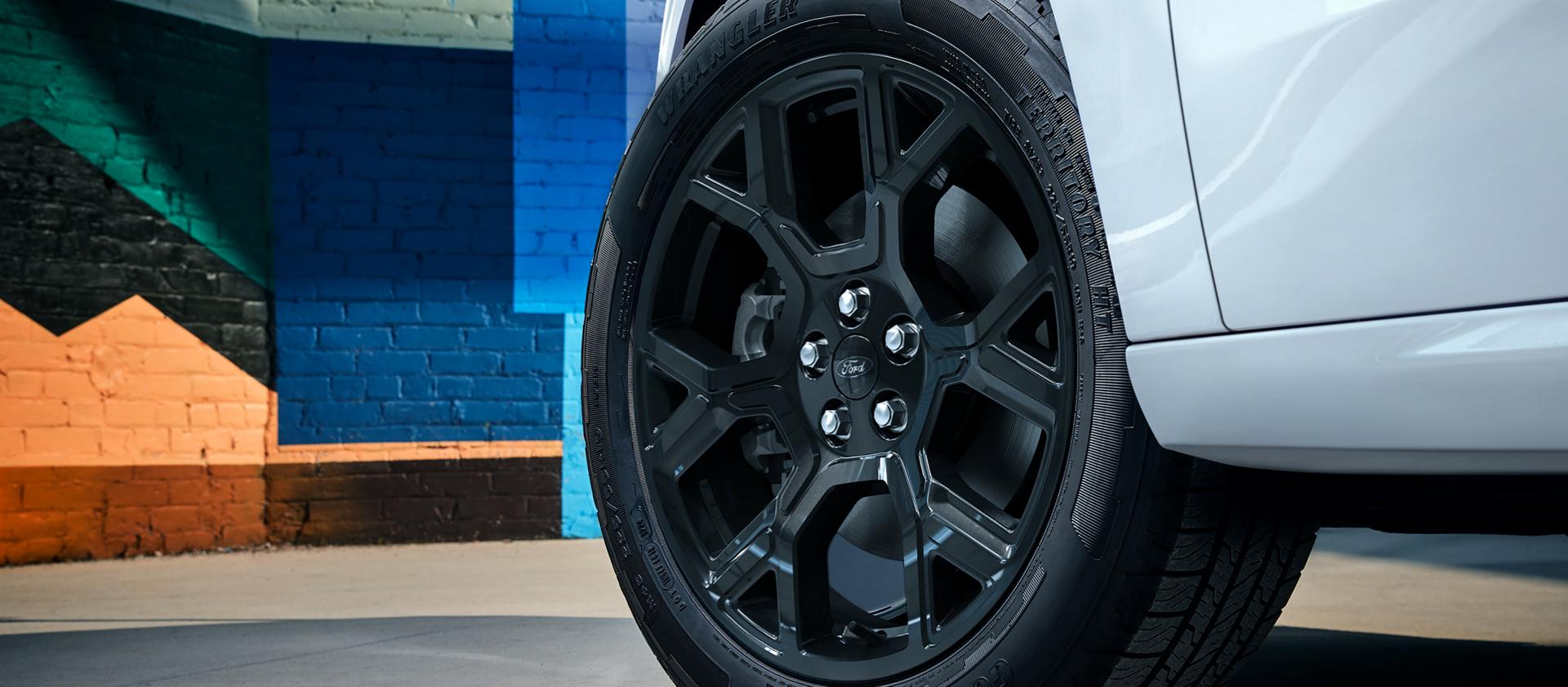 Close-up on the available 19-inch spoke wheel of a 2026 Ford Maverick Lobo™ model in Space White