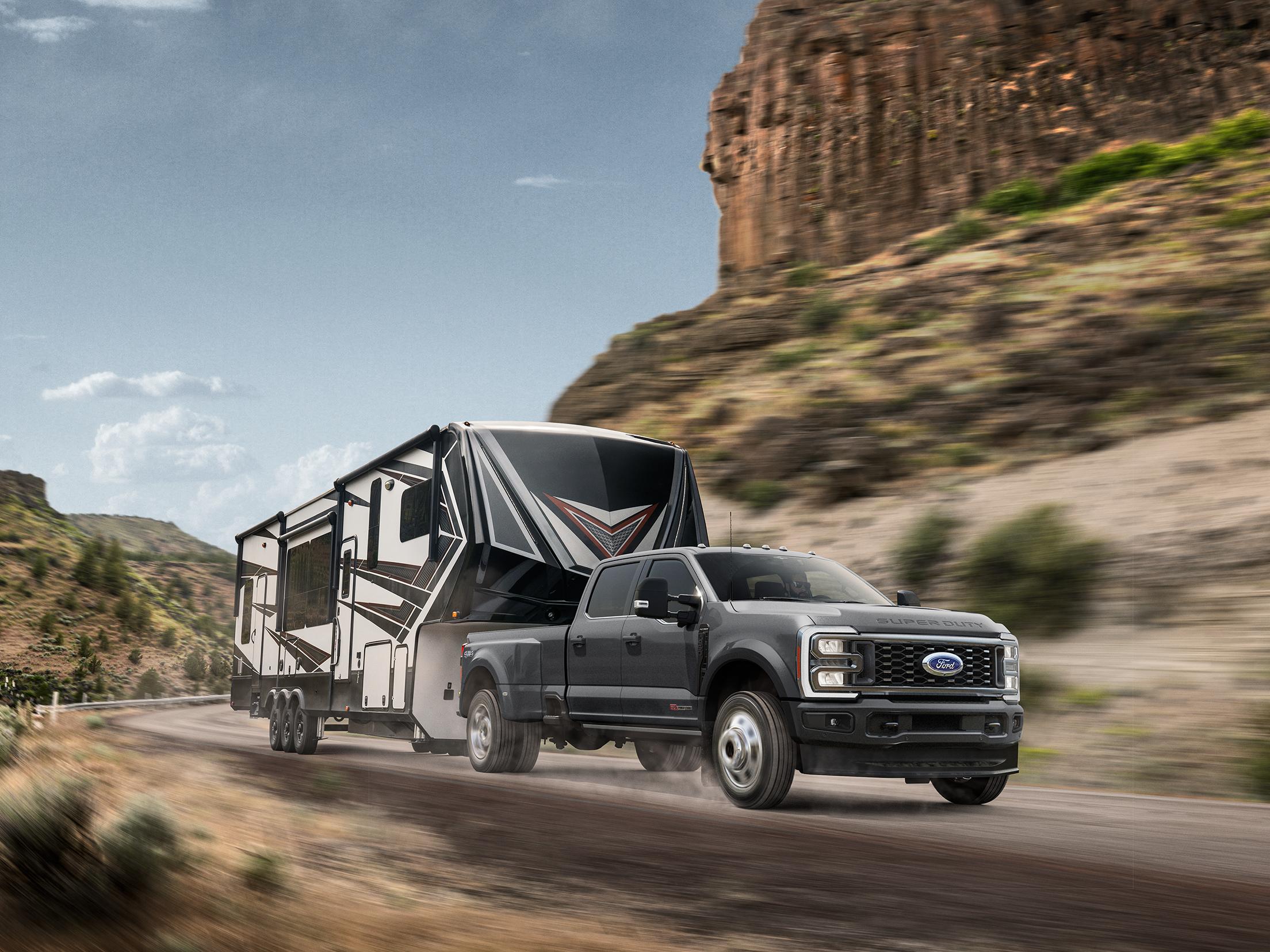 Camion Ford Super Duty® 2026 tirant une grande caravane sur une route de montagne