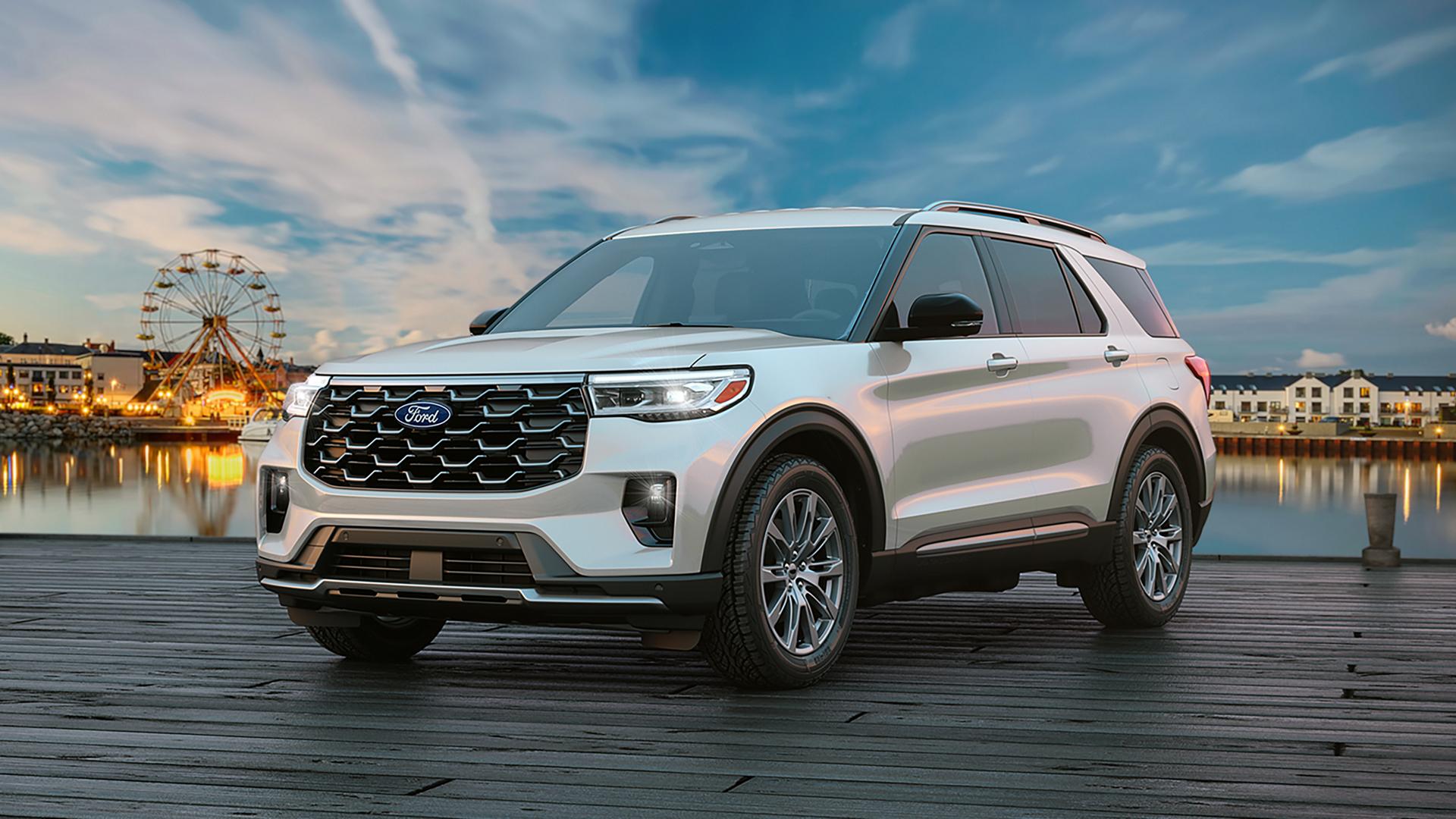 Un VUS Ford Explorer® 2027 stationné sur une jetée près d’une grande roue au crépuscule