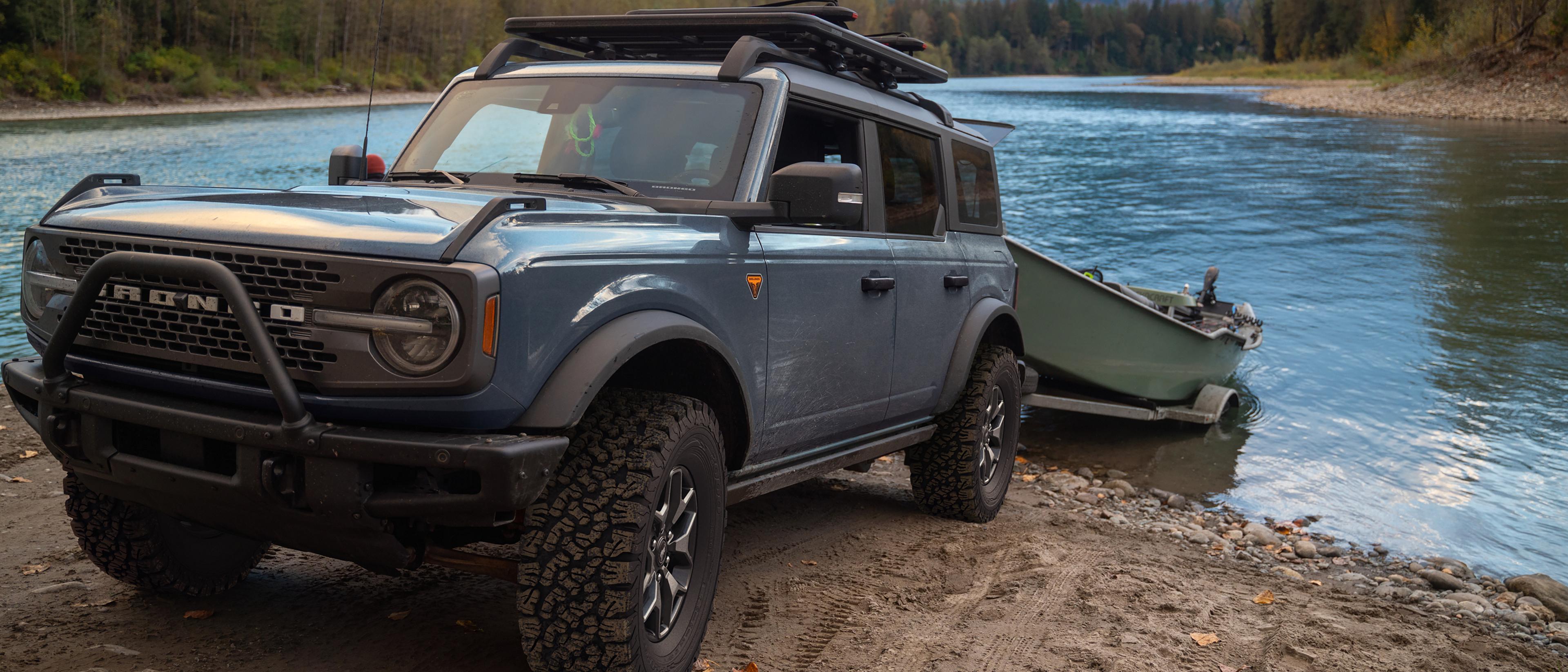 Un VUS Ford Bronco® 2025 reculant une remorque dans un lac avec un bateau dessus